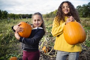 kids holding pumpkins
