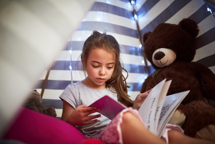 little girl reading a book 